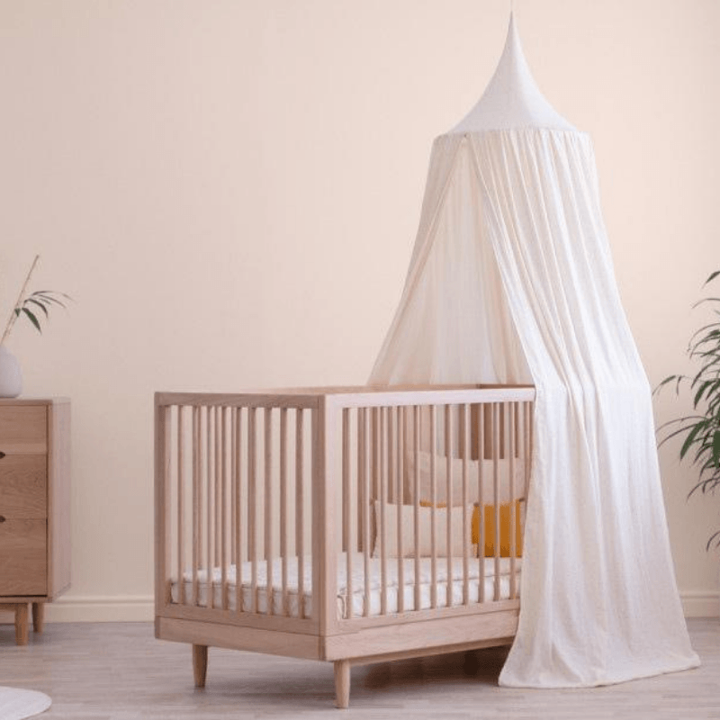 White And Gold Bed Canopy Hung In Child's Nursery