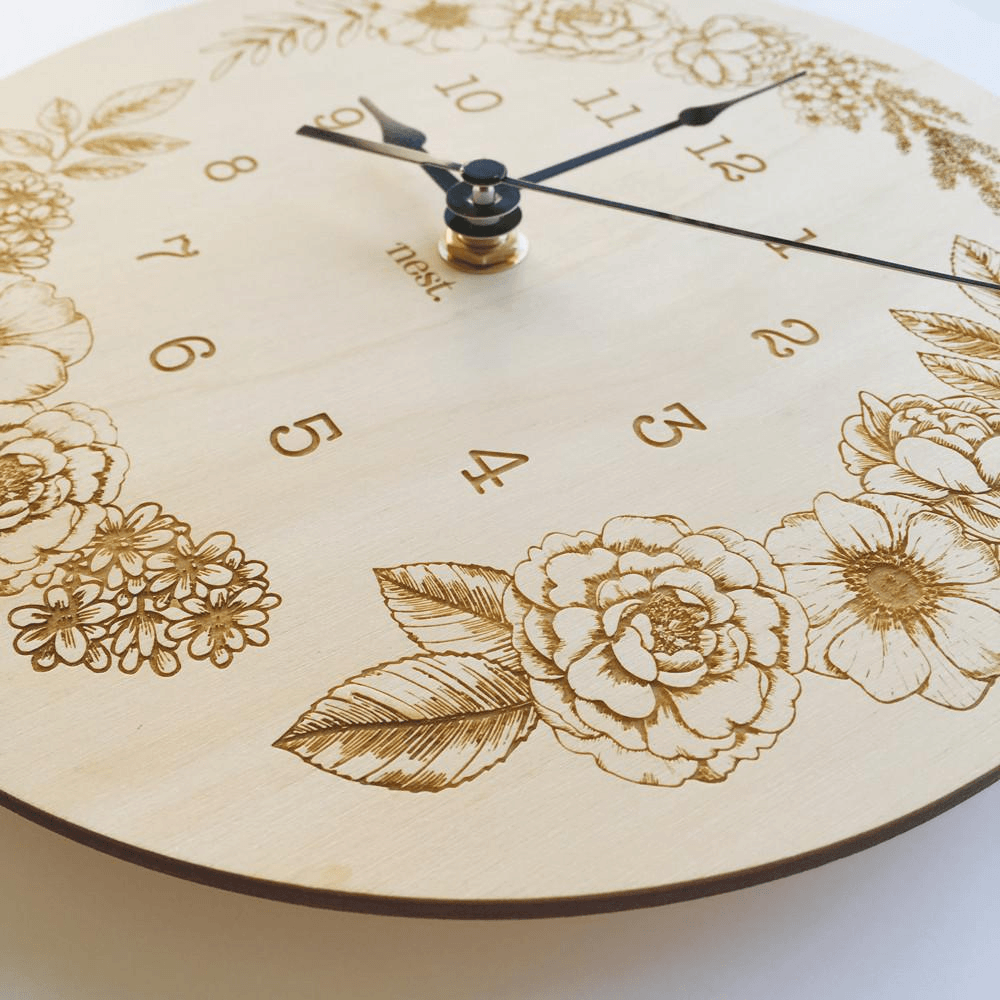 Close up of a wooden clock with floral decoration